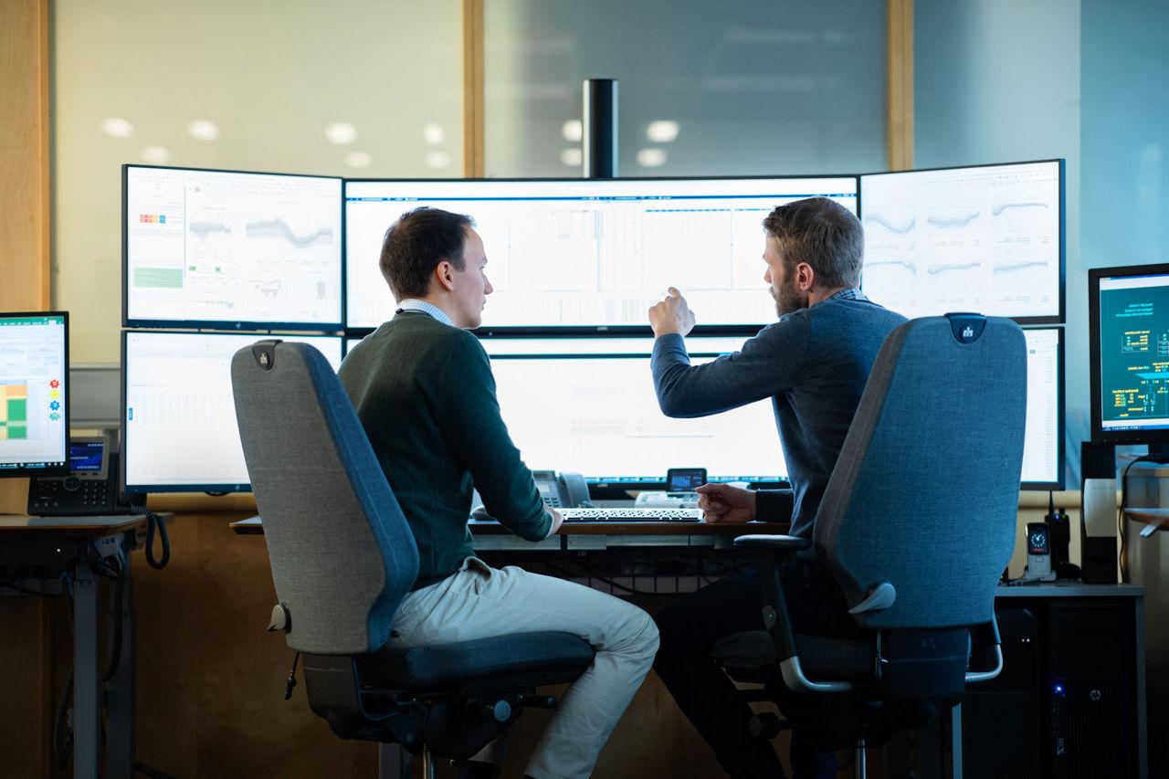 Two men in front of computers